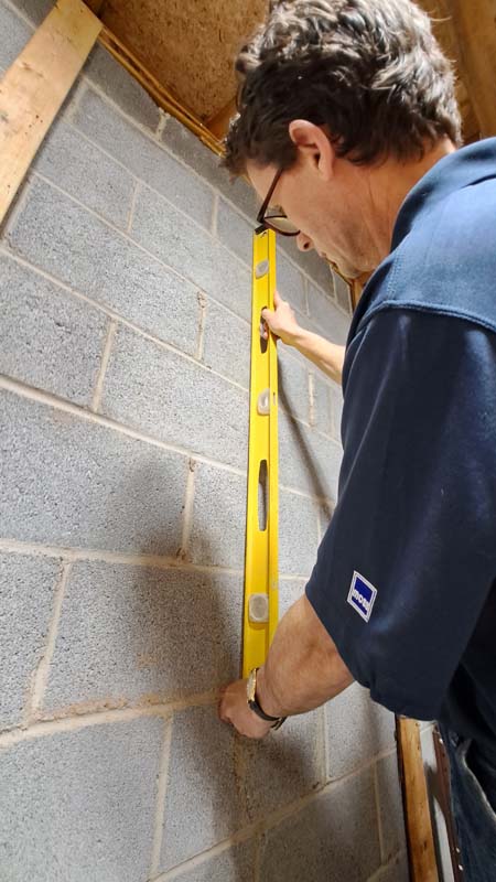home inspector measuring foundation for movement